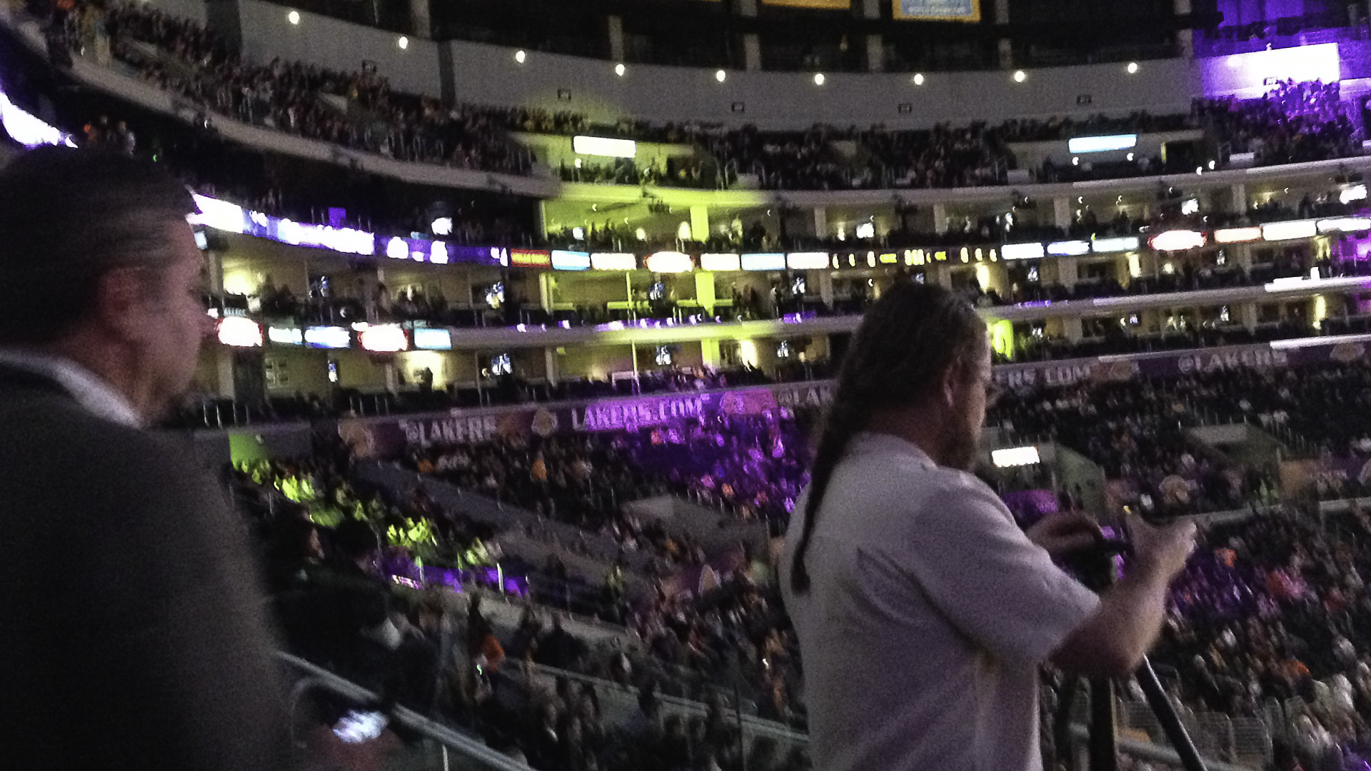 A photographer operates a camera rig from the stands during the Lakers arena capture